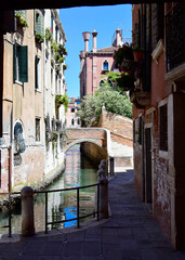 Fototapeta na wymiar Venice, Italy. Canal and narrow street in Venice