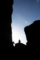 Man and woman hikers looking out to a beautiful sunset . Adventure and active lifestyle concept.