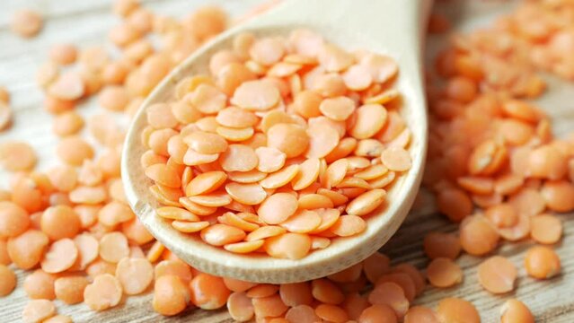 Bowl of uncooked dhal on white,
