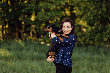 young girl on a walk with her dachshund