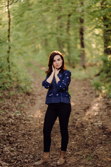 A beautiful young woman walking in the forest