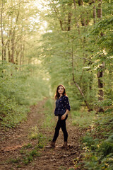 A beautiful young woman walking in the forest