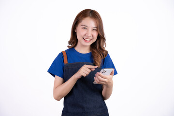 Naklejka premium Young Asian woman cafe owner feeling happy using cellphone to advertise through social media or manage electronic banking, isolate with white background, small business owner, young confident woman.