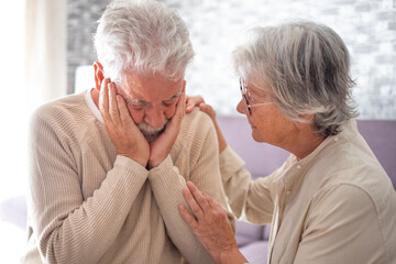 Old senior woman comforting her depressed illness husband, unhappy elderly man at home needs help. Ourmindsmatter