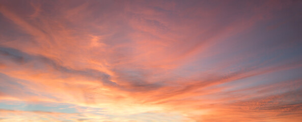 Fototapeta na wymiar romantic colorful wide sunset sky orange and blue with beautiful clouds