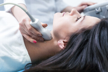 Woman endocrinologist making ultrasonography to a female patient in an ultrasound office. Ultrasound diagnostics