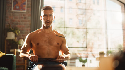 Strong Athletic Black Man Does Shirtless Workout at Home Gym, Exercising on stylish Water Rowing...