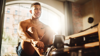 Strong Athletic Black Man Does Shirtless Workout at Home Gym, Exercising on Rowing Machine. Muscular Mixed Race Sportsman staying Healthy, Training. Successful Sweat and Determination. Low Angle - obrazy, fototapety, plakaty