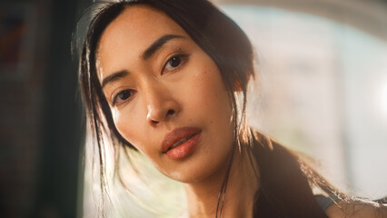 Strong Asian Female Wipes Sweat Looks at Camera. Successful Empowered Woman Fighting and Winning fight Against Injustices, Prejudices. Cinematic Stylish Sensual Face Revealing Elevating Portrait