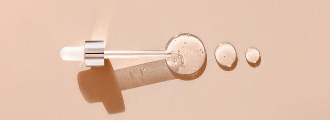 pipette drop of serum test on a beige background