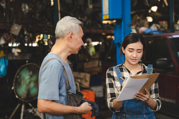 mechanic technician team wearing uniform reading or writing clipboard document and standing in auto repair shop garage, with car vehicle background, job of auto garage service concept