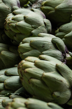 Collection of fresh artichokes in market