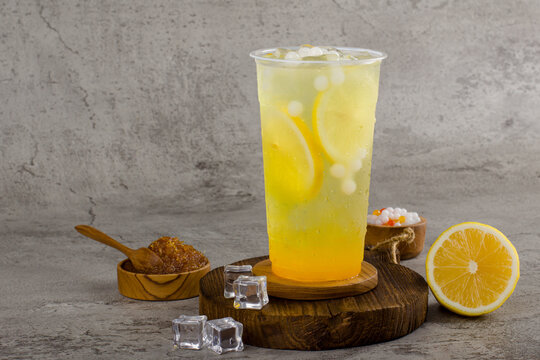 Boba or tapioca pearls is taiwan bubble milk tea in plastic cup with lemonade flavor on texture  background, summers refreshment.
