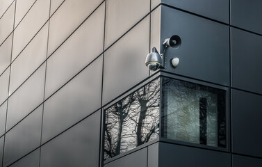 Security camera or CCTV is outsite on the wall of the modern building. Video equipment for safety...