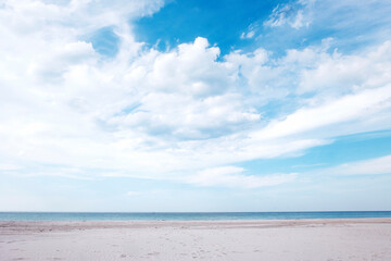 Empty beach with white sand, sea with horizon and cloudscape. Sea background.
