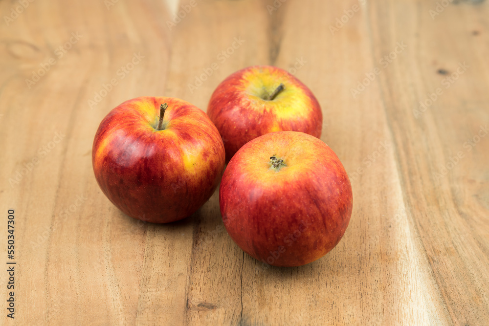 Poster red fresh apples on a wooden surface