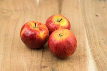red fresh apples on a wooden surface