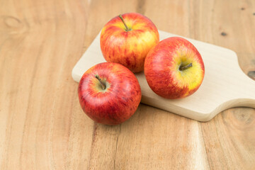 red fresh apples on a wooden surface