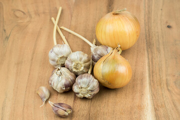 onion and garlic, composition on a wooden surface