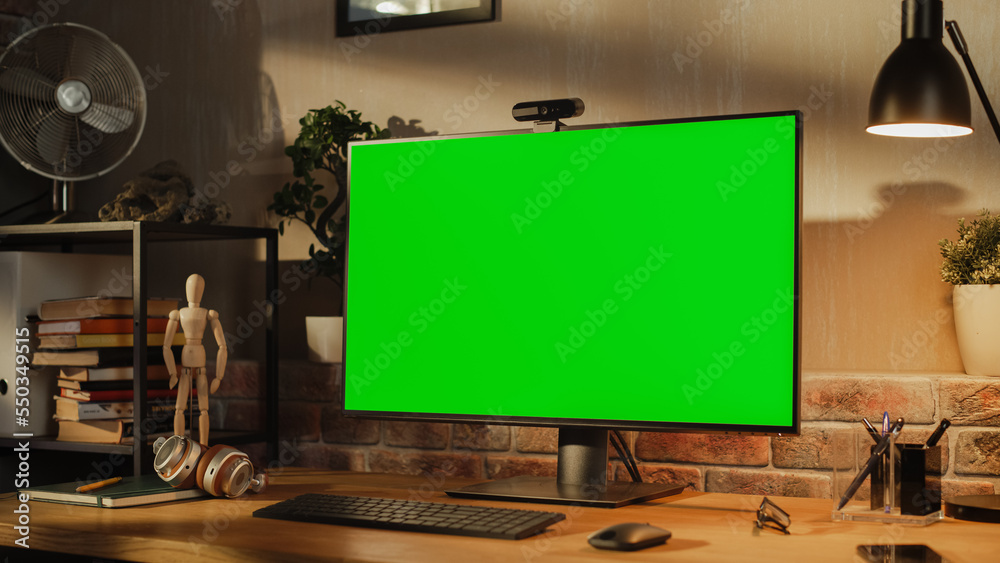 Aufkleber computer monitor with green screen standing on a wooden desk with height adjustable function. chroma