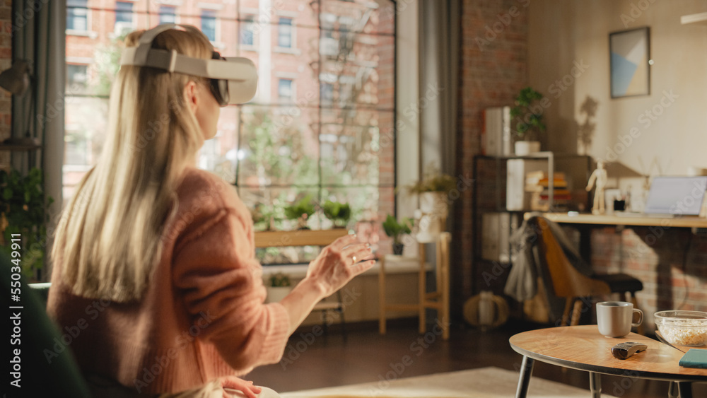Poster over the shoulder footage of a female freelancer using virtual reality headset and controllers for h
