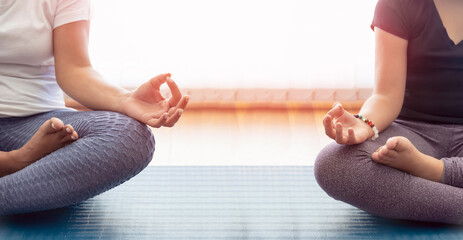 Crop women meditating in morning
