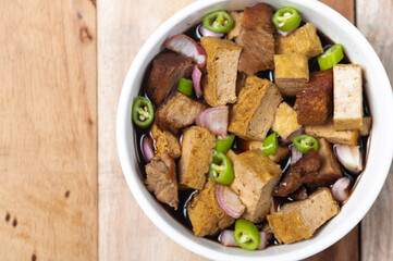 Tokwa't baboy is a typical Philippine appetizer or pulutan. It consists of pork ears, pork belly and deep-fried tofu, and is served in a mixture of soy sauce, pork broth, vinegar, chopped white onions
