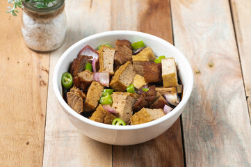 Tokwa't baboy is a typical Philippine appetizer or pulutan. It consists of pork ears, pork belly and deep-fried tofu, and is served in a mixture of soy sauce, pork broth, vinegar, chopped white onions