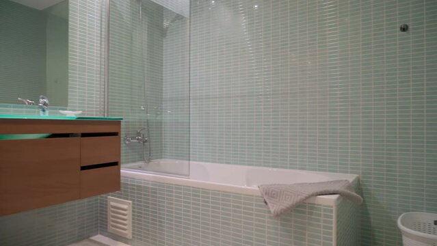 Modern bathroom toilet with shower, in a tourist hotel. towel on the bath