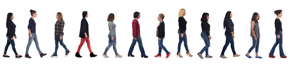 side view of group of women with jeans walk on white background