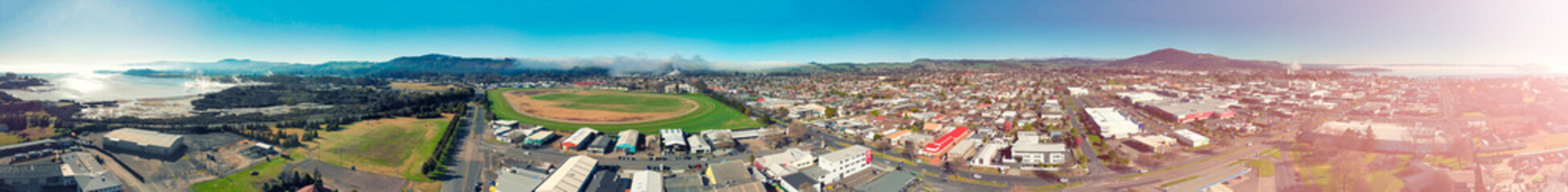 Panoramic aerial view of Rotorua landscape and geysers smoke, New Zealand from drone