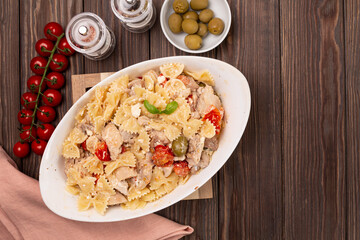 Pasta with chicken, tomatoes and feta cheese, cooked in the oven, in a large dish