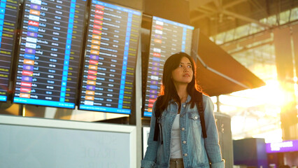 Asian traveler woman walking in airport terminal.