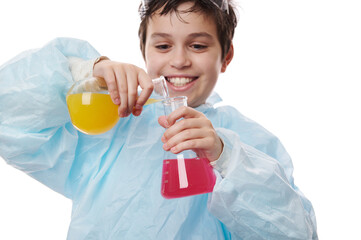 Selective focus on laboratory glass flasks with chemical fluids, in the hands of cute schoolboy -...