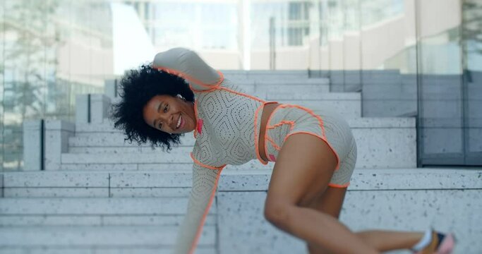 African american woman dances twerk dance in the down town center of the city, 4k