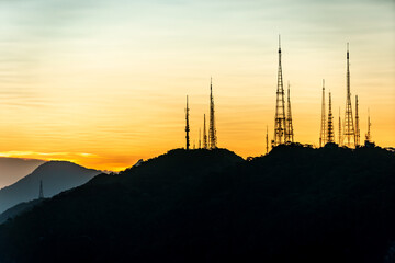sunset over the transmission towers in rio de janeiro, view from the statue of christ