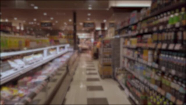 blurred out of focus slow motion view while walking through aisle row of shelf in supermarket grocerry convienent store in town shopping store merchandise