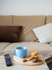 Fototapeta na wymiar Hot milk with cookie and doughnut for a snack in the living room