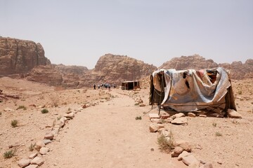 Tents with stalls with souvenirs by trail in Petra, Jordan. Petra is ancient Nabataean city,...