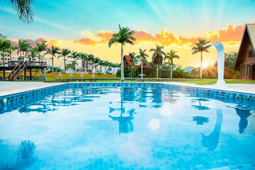 Fototapeta na wymiar pool, water, beach, swimming, resort, tropical, hotel, palm, sky, tree, summer, holiday, luxury, travel, vacation, sea, swimming pool, relaxation, tourism, ocean, nature, relax, spa, chair, paradise