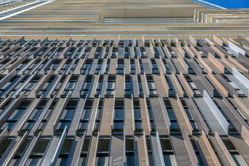 Looking up at a modern building exterior wall with geometric pattern design