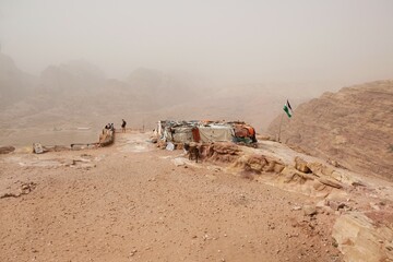 Amazing views on tourist trail to High Place of Sacrifice in ancient Nabataean city of Petra, Jordan. Top with flag and view of Petra.