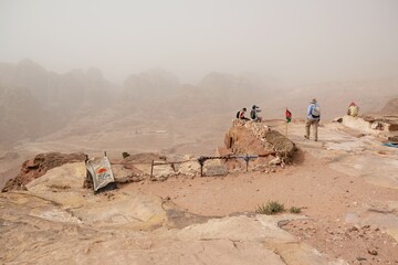 Amazing views on tourist trail to High Place of Sacrifice in ancient Nabataean city of Petra, Jordan. Top with flag and view of Petra.