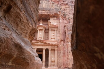Famous Treasury in Petra, Jordan. View between walls of narrow gorge al-Siq. Petra is considered...