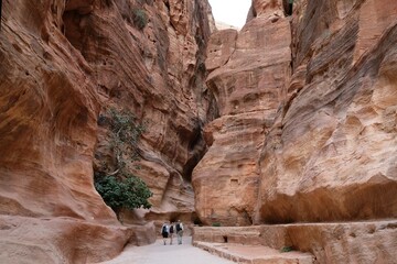 Colorful crowd of people in gorge al-Siq in Petra, Jordan. Petra is considered one of seven new...