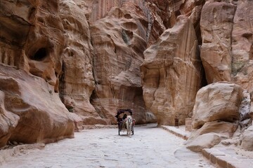 Driving horse carriage in gorge al-Siq in Petra, Jordan. Petra is considered one of seven new...