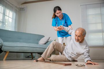 Asian older senior man falling down on lying floor and woman nurse came to help support, Disabled...