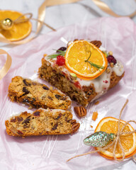 Christmas cupcake with nuts and dried fruits on a pink background with a festive atmosphere. Traditional German dessert for Christmas celebration.