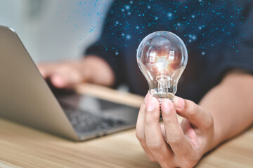 Concept of new ideas and innovation. Hands holding light bulb for Concept new idea concept with innovation and inspiration, innovative technology