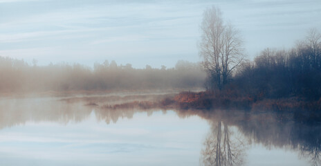 Fototapeta premium Misty morning over the river. picturesque view in nature